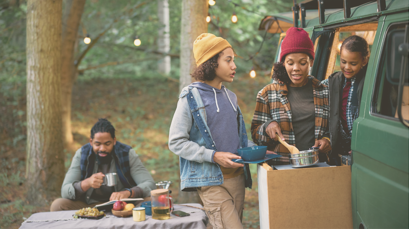 A mother preparing a meal at her RV campsite during a casual camping trip, embracing relaxed outdoor living.